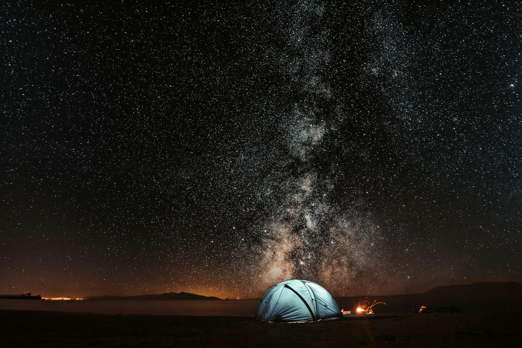 Stars over a tent at night.